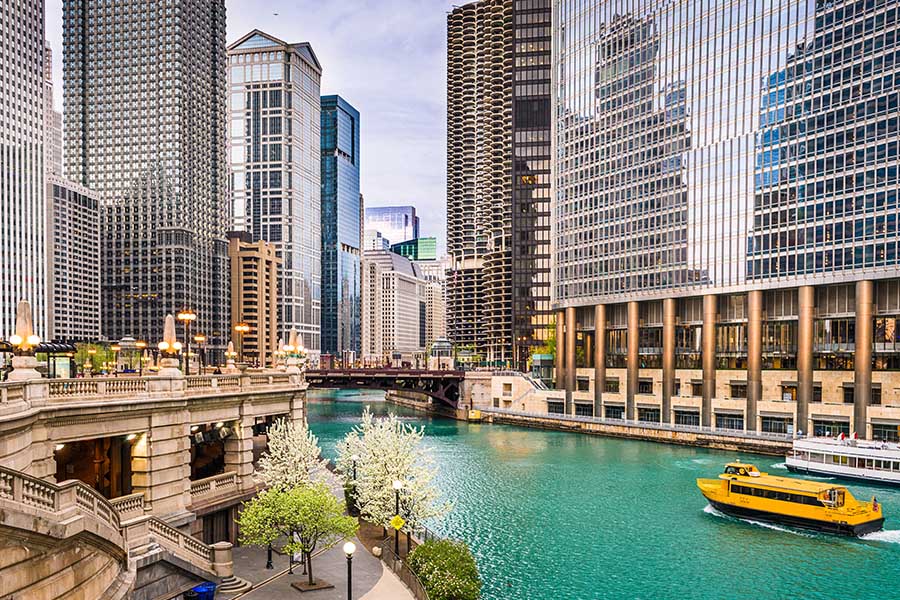 Contact - Medium Distance View of Chicago, Illinois Displaying a Yellow Sightseeing Cruise Ship and City Skyline on the River